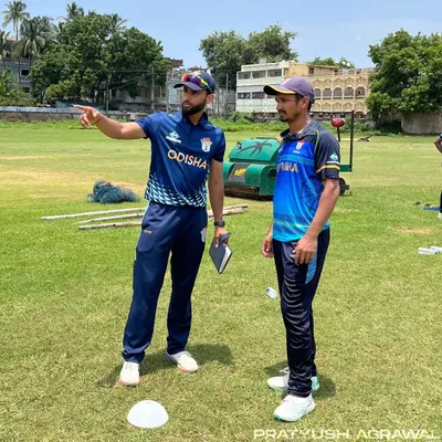 The essence of coaching is communication. Here, I am on the field with a player, pointing out a technical detail and ensuring we are on the same page. This dialogue is crucial for progress.