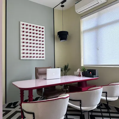 A view of a personal cabin within my studio, featuring a custom-made pink desk and a bold geometric floor. This space is designed to spark creativity and shows how I can incorporate unique personality into a professional setting.