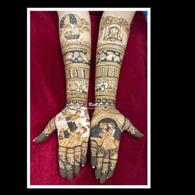 A heartwarming baby shower mehendi featuring portraits of the family. One hand shows the mom with her daughter, while the other shows the dad with their son, celebrating their growing family.