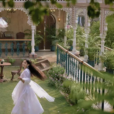 A beautiful solo portrait of the bride, capturing the graceful movement of her all-white outfit against the backdrop of a heritage location. These twirling shots are always full of life.