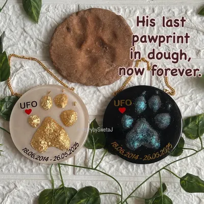 This piece is a tribute to a beloved dog named UFO. His mom sent me his last pawprint, pressed into dough. I created two memorial plaques from it: one with a celestial, shimmery design and another in brilliant gold leaf, with the original dough print shown alongside.