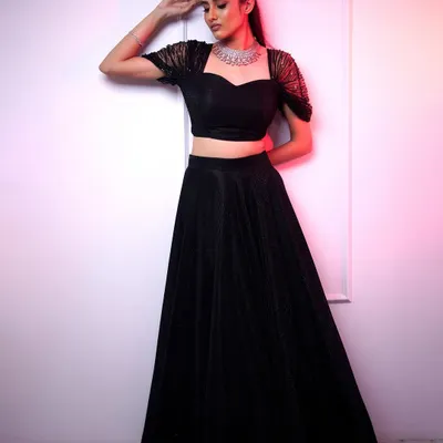 A stunning wedding guest look featuring our sleek American diamond choker. It's the perfect accessory for a modern black lehenga, adding just the right amount of sparkle.