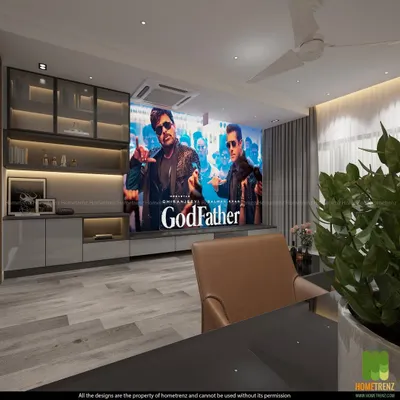 This living room doubles as a high-performance home theater. A large projector screen descends in front of the custom cabinetry, which houses the audio components and provides elegant storage, creating a seamless transition from living space to cinema.