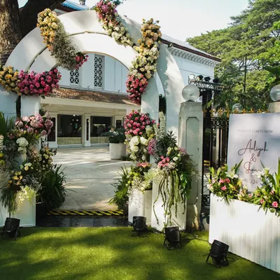 The entrance to a wedding should be a gateway to the magic inside. We created this grand floral archway to welcome guests to Aaliyah and Shane's beautiful white wedding.