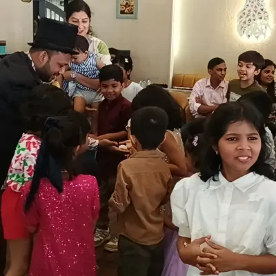 A magician from my team performing for an excited group of children at a birthday party in Navi Mumbai.