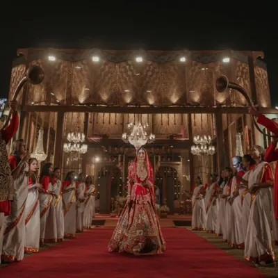 The bride's entrance is a pivotal moment. I design a grand processional, complete with a regal red carpet, traditional musicians, and dramatic lighting, to ensure her walk towards the mandap is as majestic and memorable as she deserves.