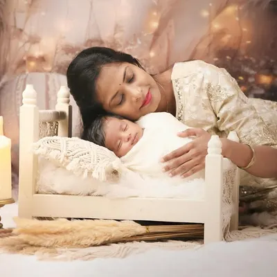 The bond between a mother and her newborn is a story I feel privileged to capture. In our cozy studio, I create a serene and warm environment for these tender moments, focusing on the quiet love and connection.