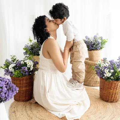 A tender kiss during a 'Mommy and Me' session. These quiet, loving moments are just as important as the big smiles, creating timeless portraits of motherhood.