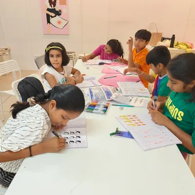 A classroom of young students diligently practicing their basic brush lettering strokes. This is where the foundation for beautiful calligraphy is built.