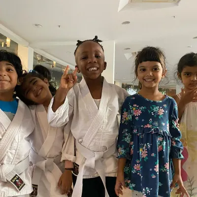 A wonderful group of smiling faces after class. Some are in their karate gis, some are in casual clothes, but everyone is part of our friendly and welcoming club.