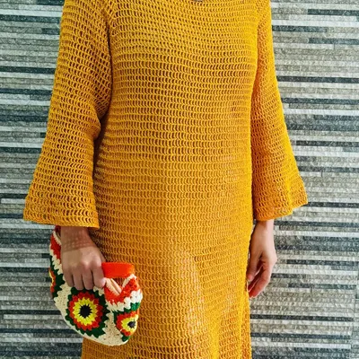 My handmade mustard bell sleeve dress, styled for a day out. It's crafted with a breathable open-weave stitch, making it a perfect statement piece or a stylish beach cover-up.