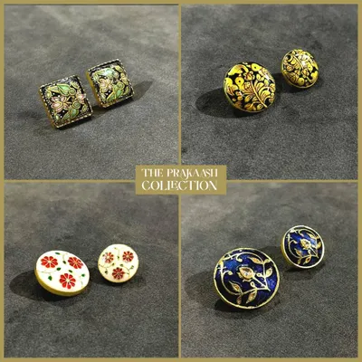 A curated selection of our handmade metal buttons, showcasing four distinct floral designs. Each set features unique color palettes, from vibrant yellow and blue to classic red and white, demonstrating our range of enamel work.
