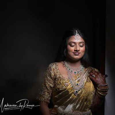 A dramatic and beautiful portrait of Pooja for her reception. The lighting highlights the flawless base and soft glam makeup.