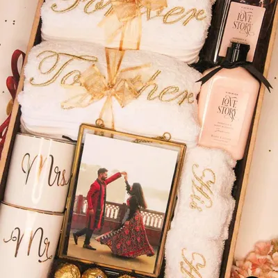 A luxurious 'Forever Together' hamper for the newlyweds. It includes personalized 'Mr & Mrs' mugs, 'His & Hers' towels, a framed photo, and other romantic goodies.