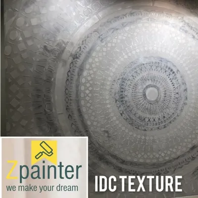 An intricate mandala design created with a metallic silver texture paint. This detailed ceiling or wall feature adds a spiritual and artistic element, with the texture creating a stunning play of light and shadow.