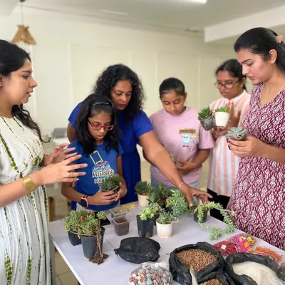 Our instructor guides a group of enthusiastic participants as they select the perfect succulents for their terrariums.