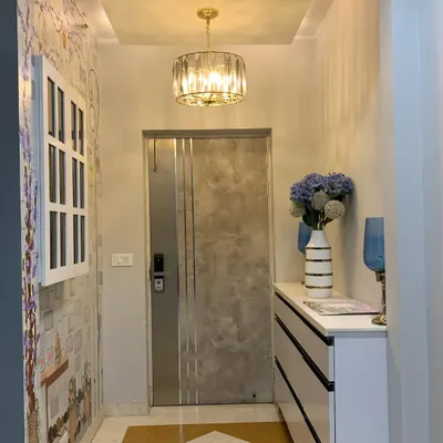 The full view of the French-themed entryway mural. The artwork, chandelier, and console table all work together to create a beautiful and welcoming first impression.