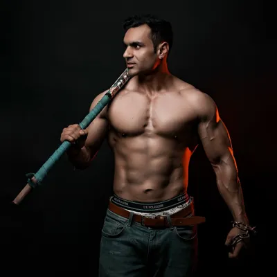 Here, I used a hockey stick as a prop to create a portrait that feels more like an athlete's profile than a standard bodybuilding shot. It adds personality and suggests a story beyond the physique.