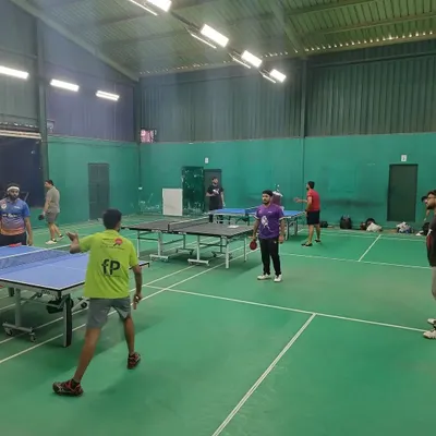 Players engaged in a lively table tennis session at our center. We provide multiple tables to ensure everyone gets plenty of play time.