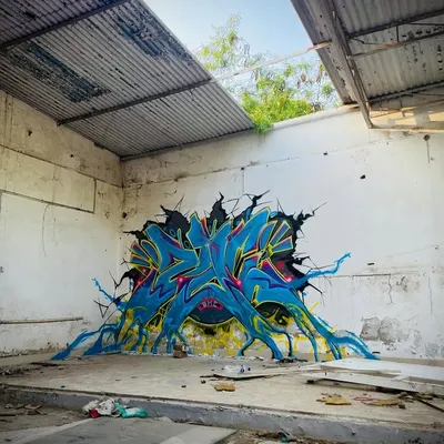 A different perspective of the 'Revival' piece, showing how the artwork seems to burst out from the dilapidated wall, bringing new life to an abandoned space.