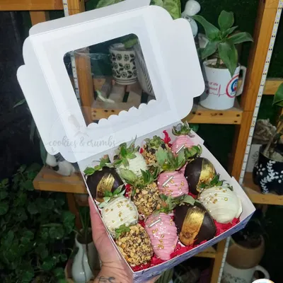A box of my fancy chocolate-dipped strawberries. This assortment includes strawberries coated in dark chocolate with gold leaf, white chocolate, and pink chocolate with sprinkles.