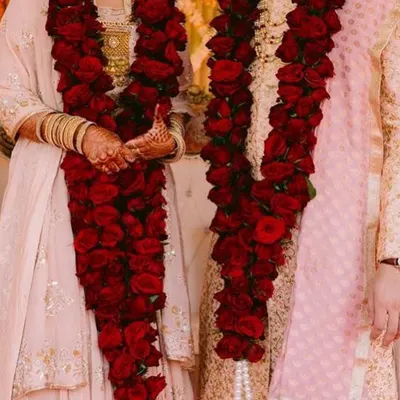 A classic jaimala made with dozens of fresh, deep red roses. I craft these dense varmalas to create a rich and timeless look for your wedding ceremony, ensuring they feel substantial and look stunning in photos.