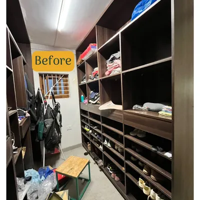 This is the before shot of a walk-in closet where shoes and bags were disorganized, making it hard to find pairs and creating a cluttered look.