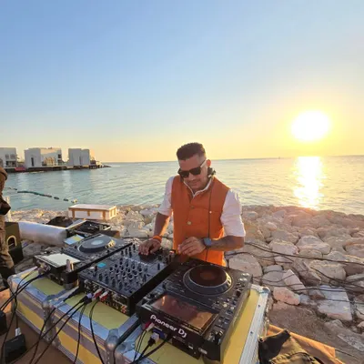 A solo DJ set against a stunning sunset in Bahrain. As a destination wedding DJ, I am an expert at creating the perfect soundtrack for beautiful, picturesque moments like this.