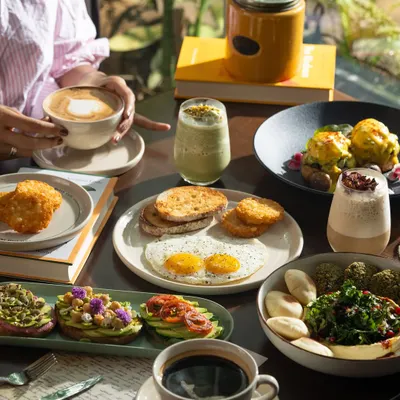 A full brunch spread with coffee, eggs, avocado toast, and more. This shot captures the ideal weekend brunch experience.