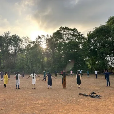 A key component of our training philosophy is building overall physical preparedness. This image from one of our youth camps shows participants engaging in outdoor stretching and conditioning exercises to improve flexibility and prevent injury.