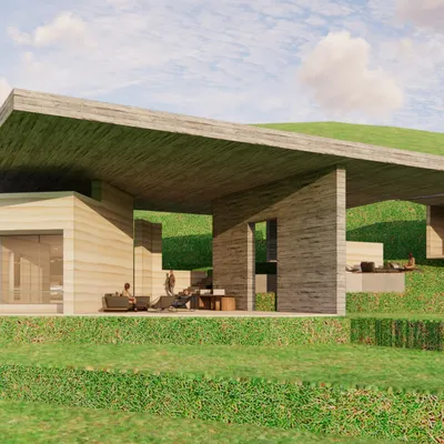 A closer look at the informal hangout space for a retreat in Almora. The design uses a mix of rammed earth and concrete under a large overhang, creating a sheltered outdoor area that feels both grand and intimate within the vast mountain landscape.