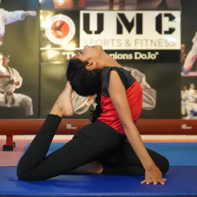 Flexibility is just as important as strength. Here, a student demonstrates an advanced yoga pose, showcasing the balance and control we cultivate.