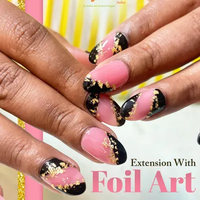 A bold and luxurious look featuring almond-shaped nail extensions with a modern pink and black design, highlighted by delicate gold foil art for a touch of glamour.