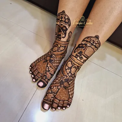 Our team's artistry extends to creating stunning bridal leg henna. This design features decorated elephants in a traditional style, with detailed patterns covering the entire foot for a truly complete look.