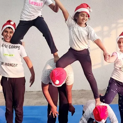 Getting into the festive spirit with a Christmas-themed acrobatic pose. The Santa hats add a touch of holiday cheer to our strength and balance work.