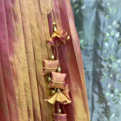 A close-up of the beautiful, handcrafted tassels I created for a lehenga skirt. These were made by upcycling an old silk saree into a new outfit.