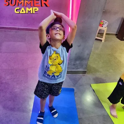 Look at this little rockstar reaching for the sky. My kids' yoga classes are filled with playful energy, helping children learn about their bodies and develop coordination in a non-competitive and encouraging environment.