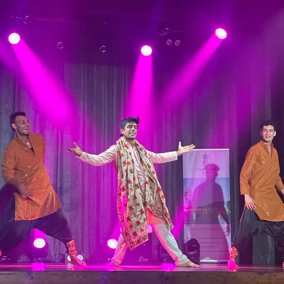 We make sure the groom and his friends own the stage. This photo captures the joy and energy of a Bollywood group performance, a perfect addition to any sangeet or wedding celebration.