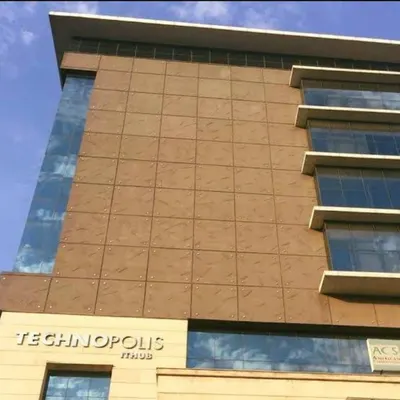 The facade of the Technopolis IT Hub, showcasing its clean lines and material combination. The design has remained relevant and functional for nearly two decades, a hallmark of our forward-thinking approach to corporate architecture.