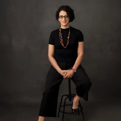 A professional portrait should radiate confidence and approachability. Here, we used a classic seated pose against a textured backdrop to create a headshot that is both strong and engaging, perfect for making a great first impression.