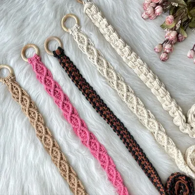 My handmade macrame belts, perfect for adding a bohemian touch to any outfit. Pictured here are five different color options, from neutral off-white and earthy brown to bold pink, each featuring a beautiful knotted pattern and a smooth wooden ring buckle. I can customize the size and color for a perfect fit.