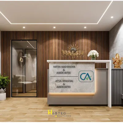 The reception area is the first thing a client sees, and for this CA office in New Delhi, I designed a space that is both impressive and professional. The custom desk prominently features the firm's branding, set against a warm, vertically-paneled wood wall.