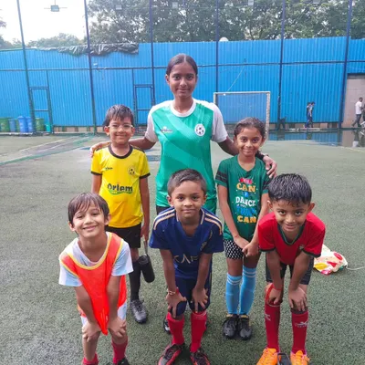 A coach with our weekend batch, which includes young girls just starting their football journey. We are proud to offer an inclusive environment for all.
