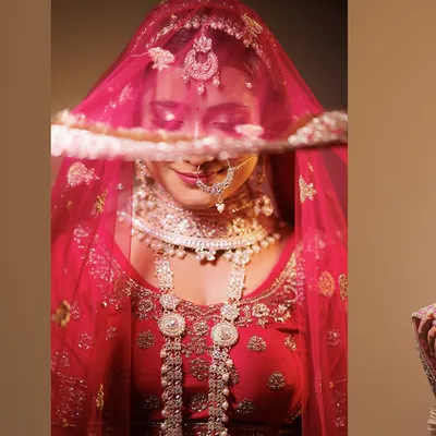 A classic, elegant bridal portrait. We use a simple background and soft lighting to draw all attention to the bride, her intricate jewelry, and the delicate veil covering her eyes.