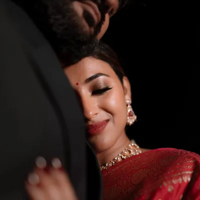 A close-up portrait capturing a moment of pure contentment and love. This intimate shot focuses on the bride's serene expression as she rests in her partner's embrace.