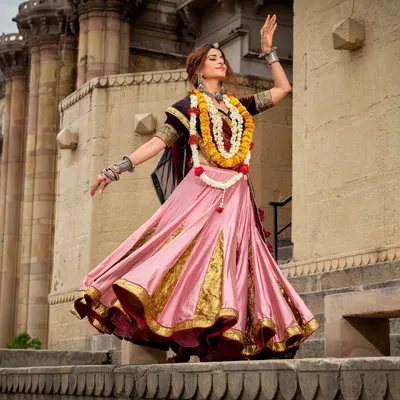 A vibrant and energetic look styled for a Navratri campaign. The pink and gold lehenga is perfect for garba, styled with traditional silver jewellery and a floral garland for an authentic touch.