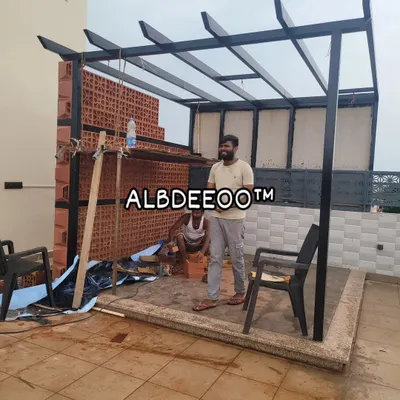 My team at work on a custom terrace pergola. This shot shows the black mild steel frame being erected and the start of a beautiful terracotta jali brick wall, which adds a traditional touch and privacy.
