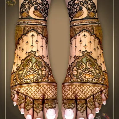 An elegant bridal feet design featuring parrots and lotus motifs. The use of negative space and delicate dot work gives it a light and graceful feel.