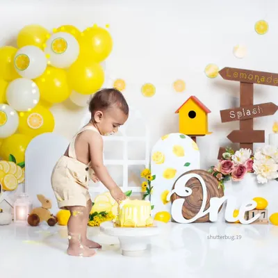 A little one getting his first taste of birthday cake during our bright and cheerful lemonade-themed cake smash.