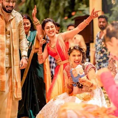 The Haldi is pure joy. Here I am with my sister, sharing a laugh during the celebrations. I love helping families create these fun, spontaneous moments of dance and connection.